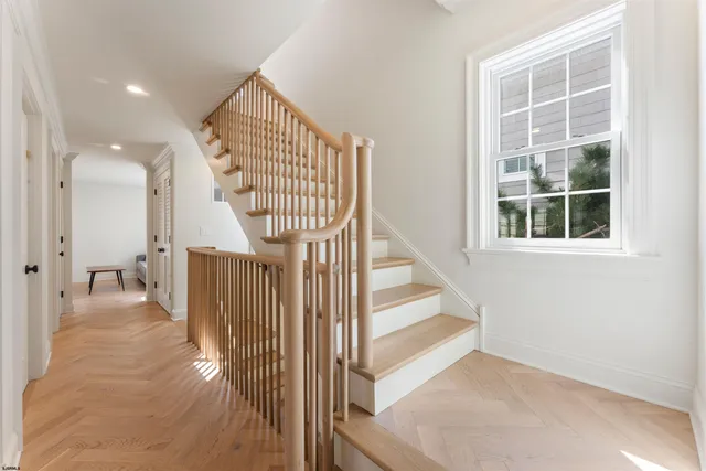 a view of entryway and hall with wooden floor