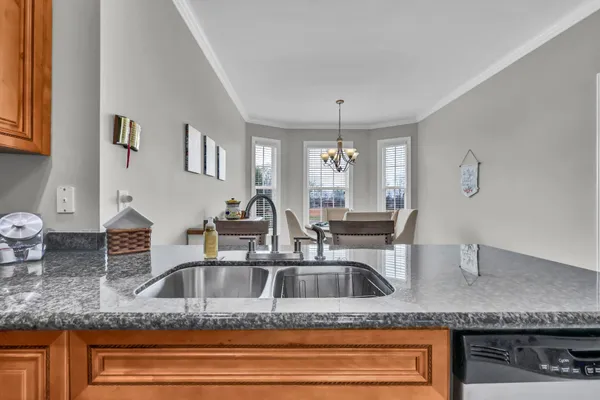 a kitchen with sink and mirror