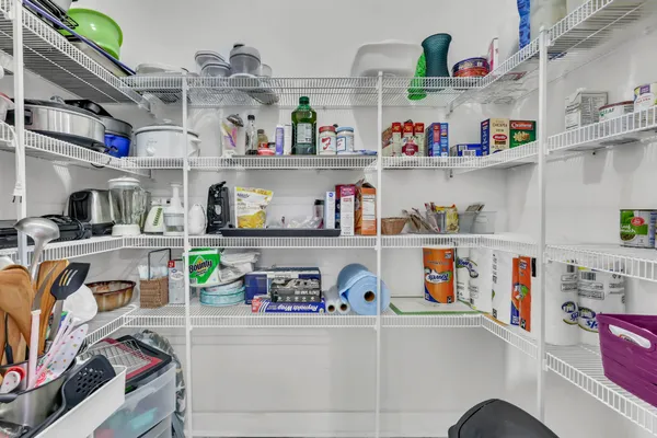 a utility room with lots of clutter and stainless steel appliances