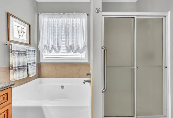 a bathroom with a bathtub and a window