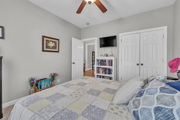 a bedroom with a bed and a flat screen tv