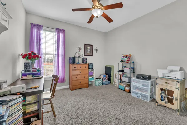 a room with furniture a baby crib and a window