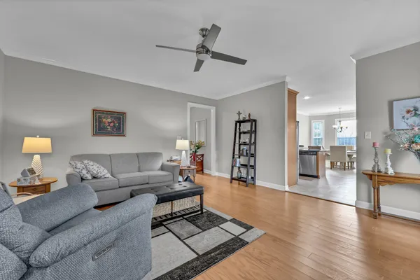 a living room with furniture and wooden floor