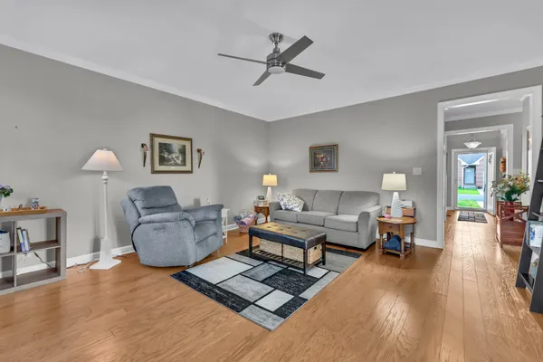 a living room with furniture and a wooden floor