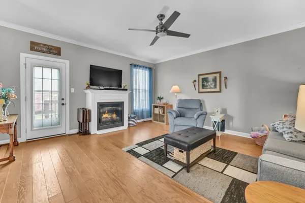 a living room with furniture fireplace and flat screen tv