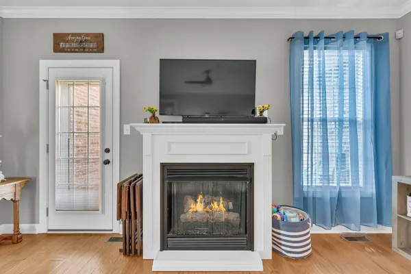 a living room with a fireplace and a window