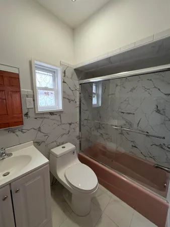 a bathroom with a toilet sink and shower