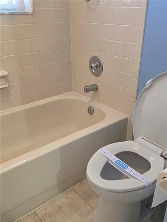 a bathroom with a bathtub and toilet