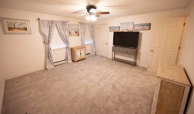 a view of a livingroom with furniture and a ceiling fan
