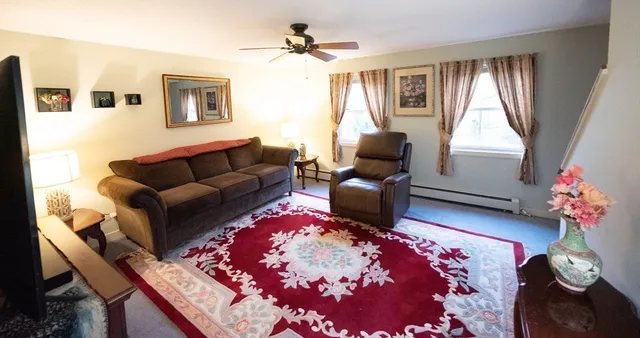 a living room with furniture rug and a window