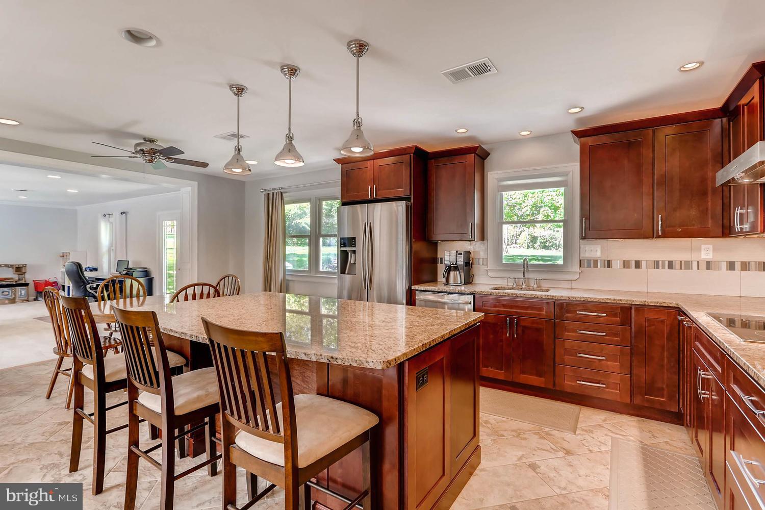 14202 Sunburst Road Baldwin, MD 21013 - Photo 11 of 29 a large kitchen with a dining table and chairs