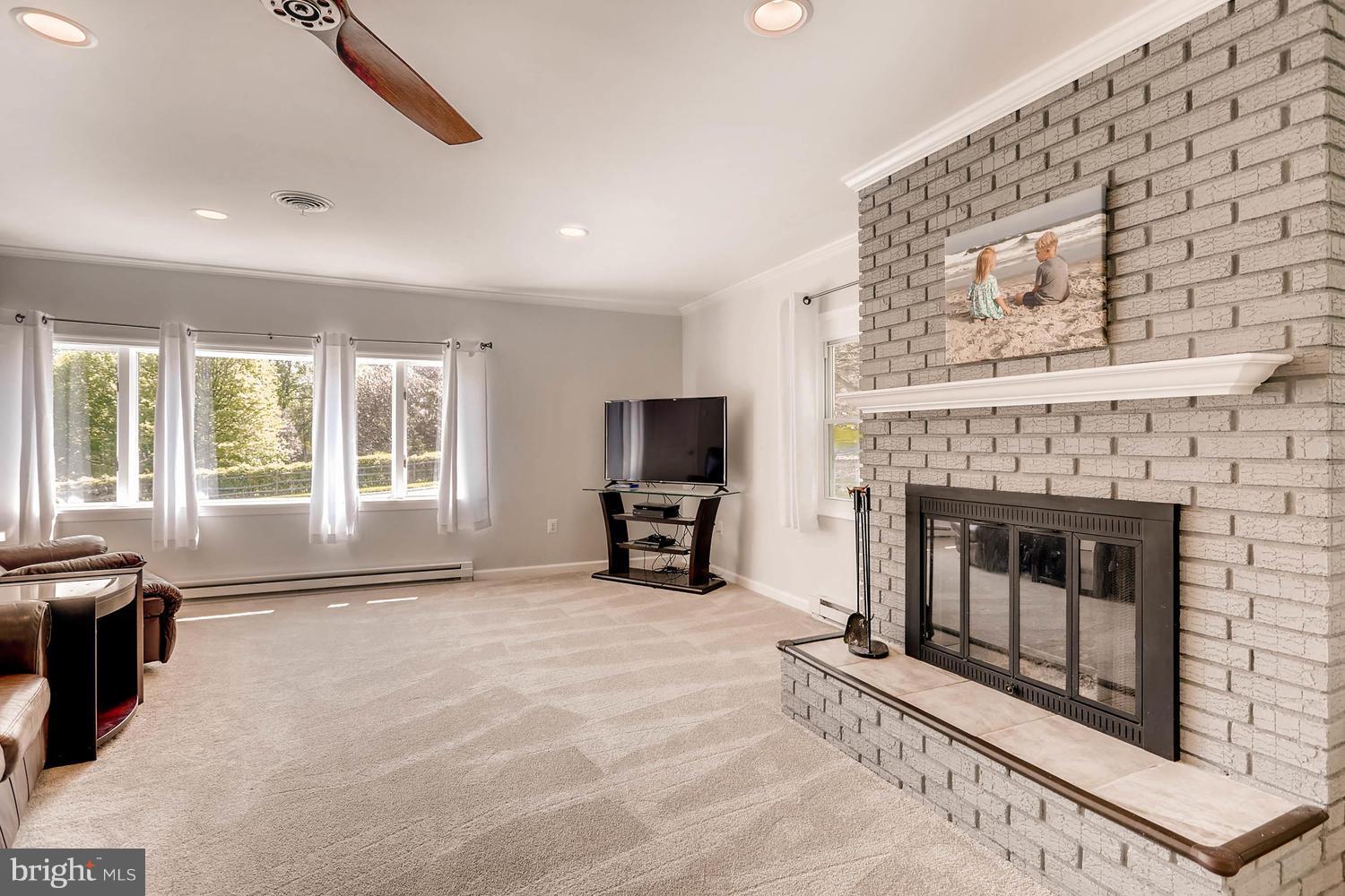 14202 Sunburst Road Baldwin, MD 21013 - Photo 15 of 29 a living room with furniture and a fireplace