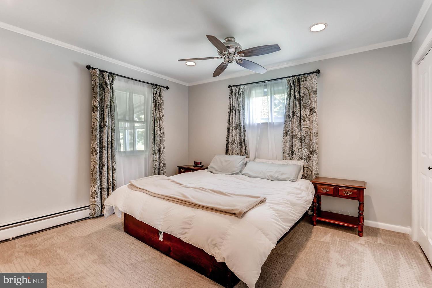 14202 Sunburst Road Baldwin, MD 21013 - Photo 16 of 29 a bedroom with a bed and a chandelier