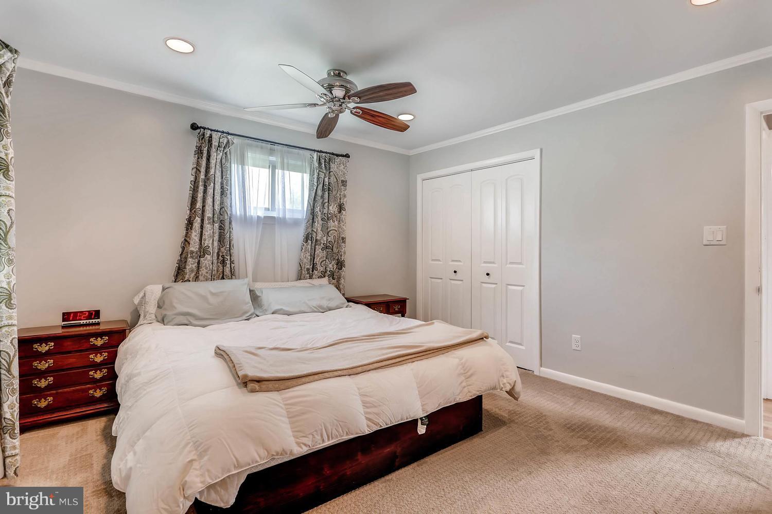 14202 Sunburst Road Baldwin, MD 21013 - Photo 17 of 29 a bedroom with a bed and a chandelier