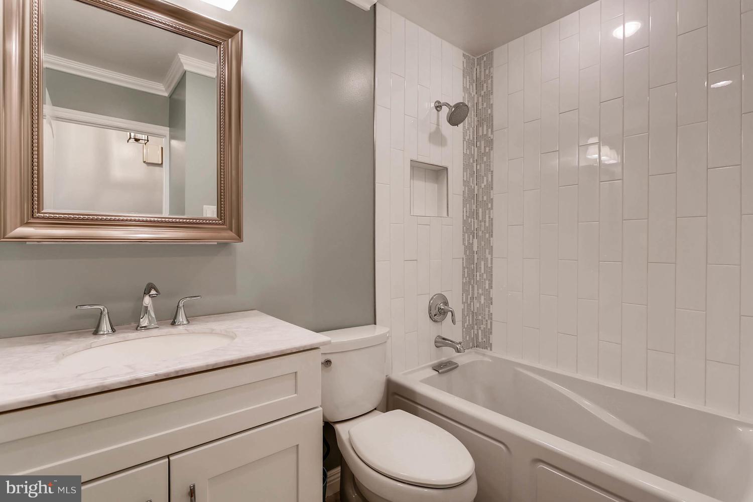 14202 Sunburst Road Baldwin, MD 21013 - Photo 21 of 29 a bathroom with a granite countertop toilet a sink and a bathtub