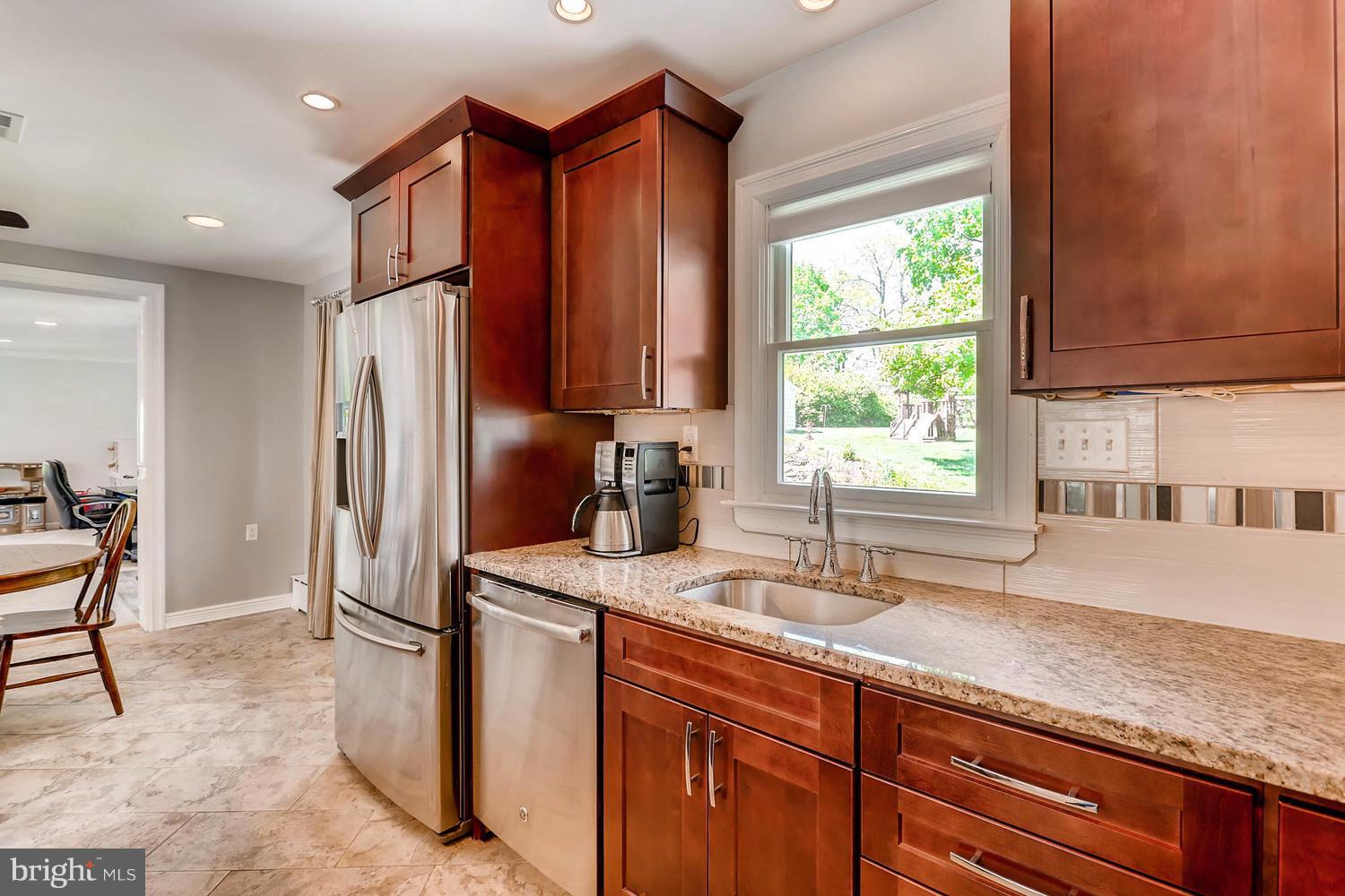 14202 Sunburst Road Baldwin, MD 21013 - Photo 10 of 29 a kitchen with stainless steel appliances granite countertop a sink and a refrigerator