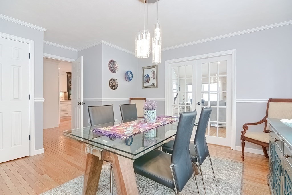 18 Carnation Circle, Unit B Reading, MA 01867 - Photo 17 of 42 a view of a dining room with furniture and wooden floor