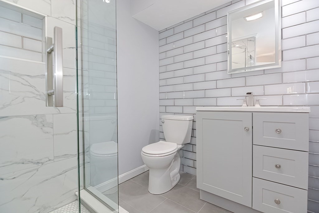 18 Carnation Circle, Unit B Reading, MA 01867 - Photo 18 of 42 a bathroom with a toilet sink and mirror