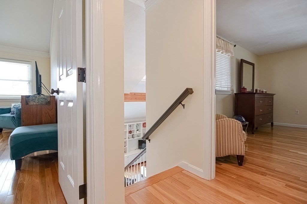 18 Carnation Circle, Unit B Reading, MA 01867 - Photo 23 of 42 a hallway with couch and wooden floor