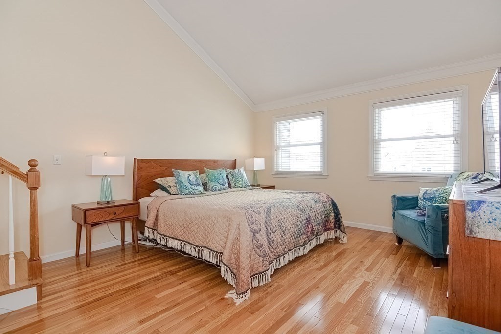18 Carnation Circle, Unit B Reading, MA 01867 - Photo 24 of 42 a bedroom with a bed and wooden floor
