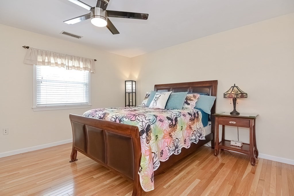 18 Carnation Circle, Unit B Reading, MA 01867 - Photo 28 of 42 a bedroom with a bed and a chandelier