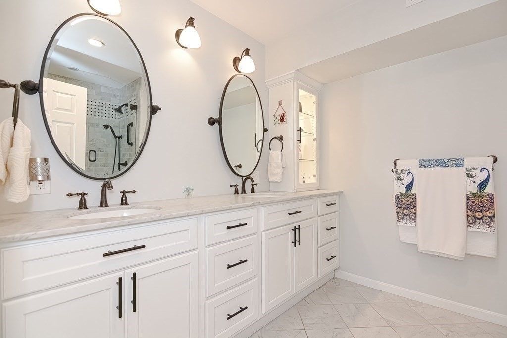 18 Carnation Circle, Unit B Reading, MA 01867 - Photo 30 of 42 a bathroom with a double vanity sink and a mirror