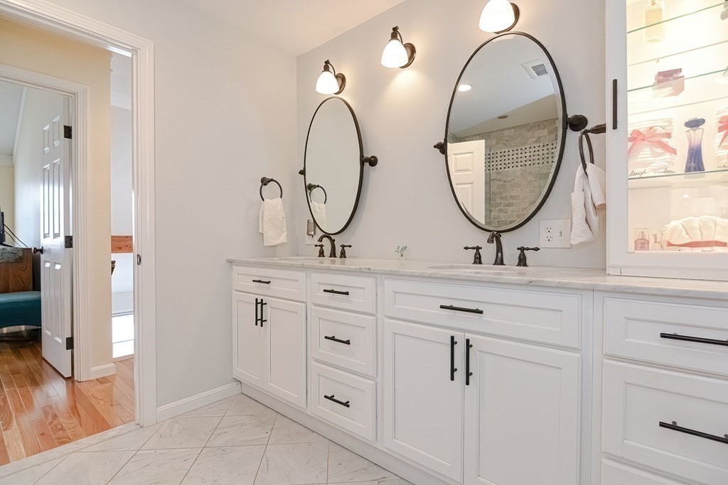 18 Carnation Circle, Unit B Reading, MA 01867 - Photo 32 of 42 a bathroom with a double vanity sink and a mirror