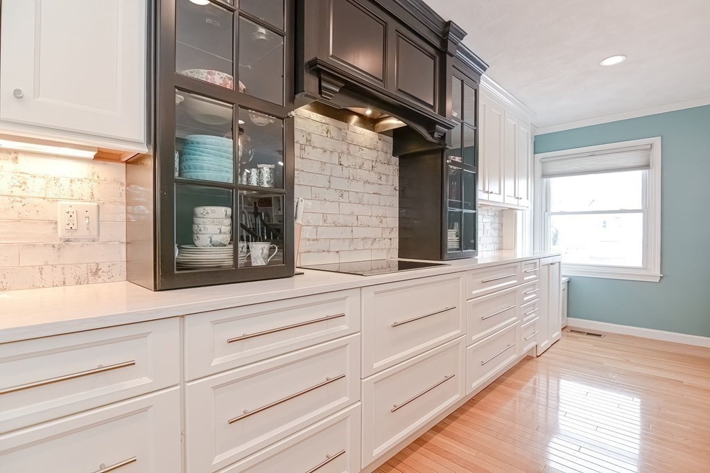 18 Carnation Circle, Unit B Reading, MA 01867 - Photo 7 of 42 a bathroom with a sink and a large mirror next to a window