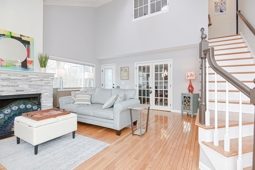 18 Carnation Circle, Unit B Reading, MA 01867 - Photo 9 of 42 a living room with furniture and a fireplace