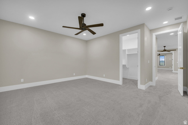 2828 Jojo Road Eagle Mountain, UT 84005 - Photo 35 of 63 Spacious room featuring neutral carpet flooring, recessed lighting, a dark-toned ceiling fan, and white trim