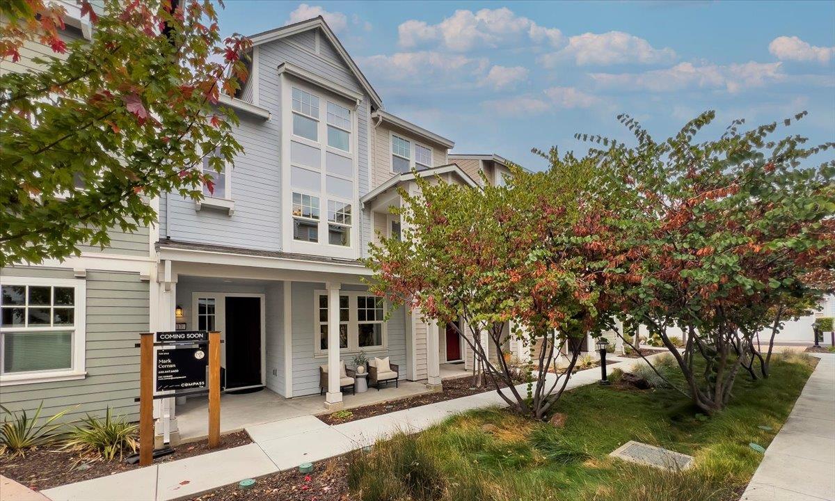 a view of a house with backyard and sitting area
