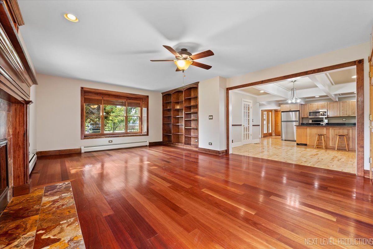 13753 McKanna Road Minooka, IL 60447 - Photo 11 of 26 an empty room with wooden floor and windows