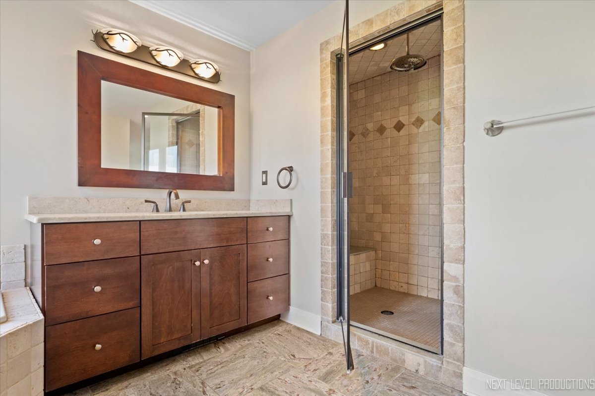 13753 McKanna Road Minooka, IL 60447 - Photo 15 of 26 a bathroom with a shower sink vanity and mirror