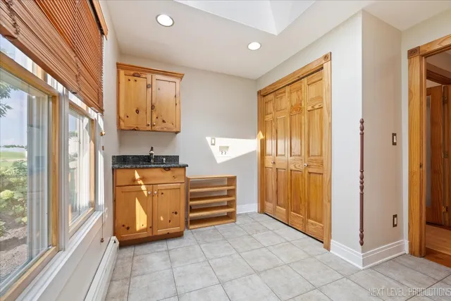 a view of kitchen with stainless steel appliances granite countertop a refrigerator and cabinets