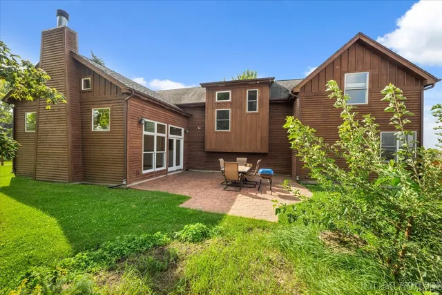 a view of a brick house with a small yard and plants