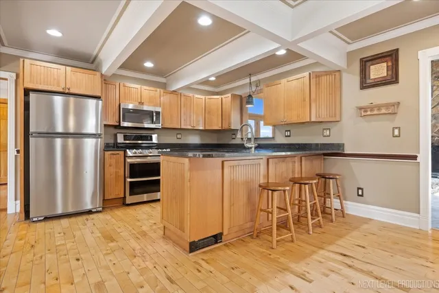 a kitchen with stainless steel appliances granite countertop a refrigerator stove top oven and sink