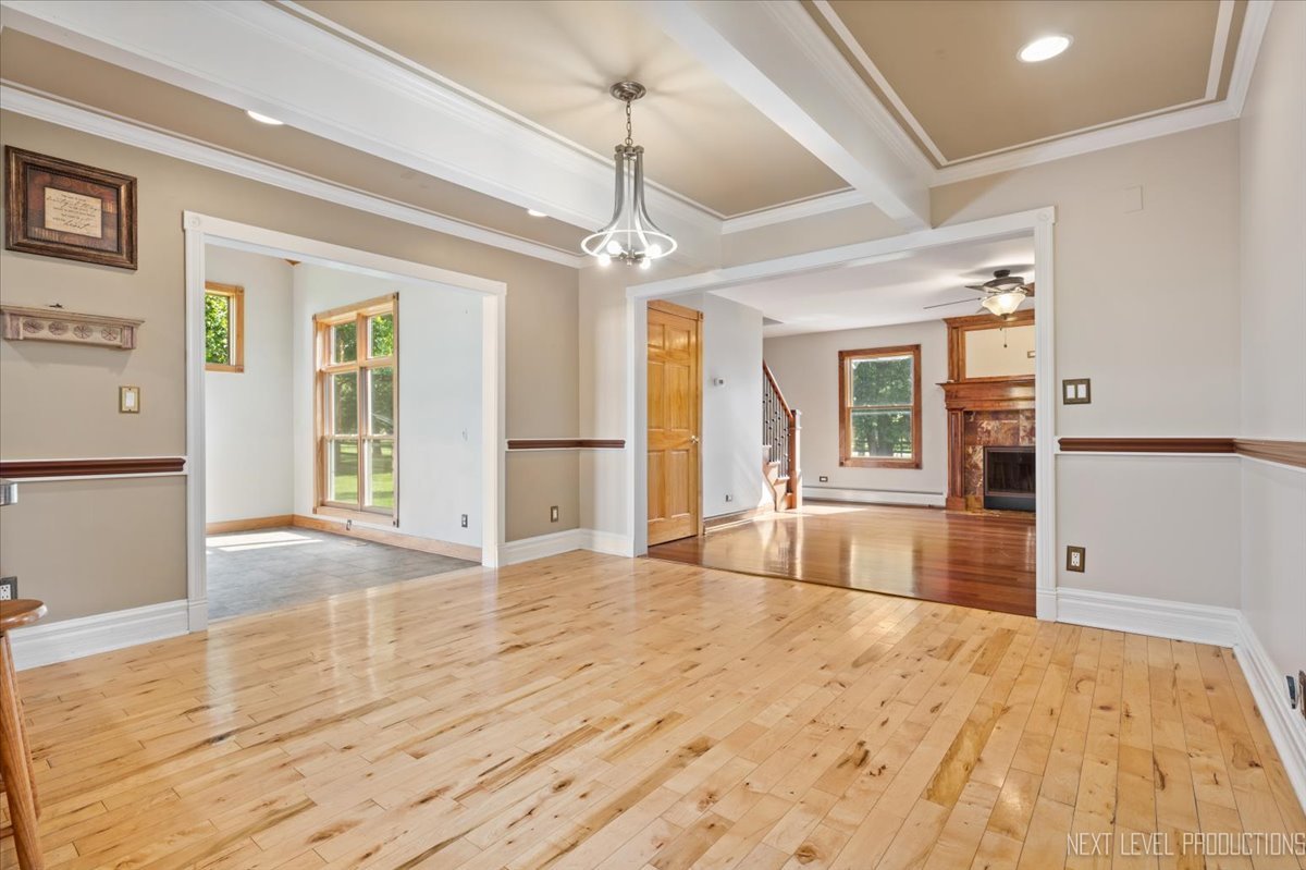 13753 McKanna Road Minooka, IL 60447 - Photo 8 of 26 a view of a livingroom with wooden floor and a ceiling fan