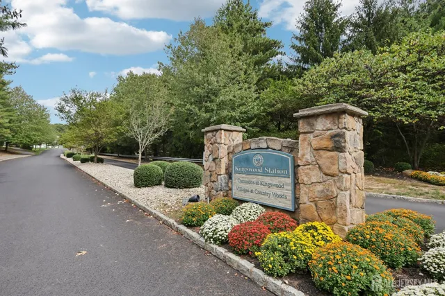 a backyard of a house with lots of green space and fountain