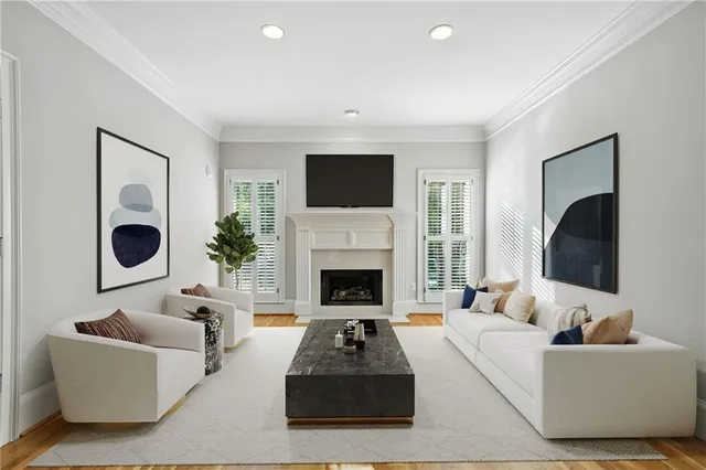 a living room with furniture a flat screen tv and a fireplace