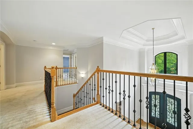 a bedroom with a bed couches and windows