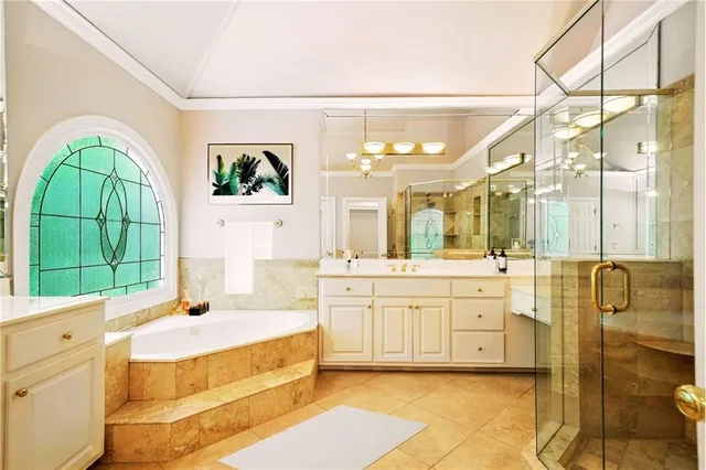 a bedroom with a bed and a flat tv screen on dresser