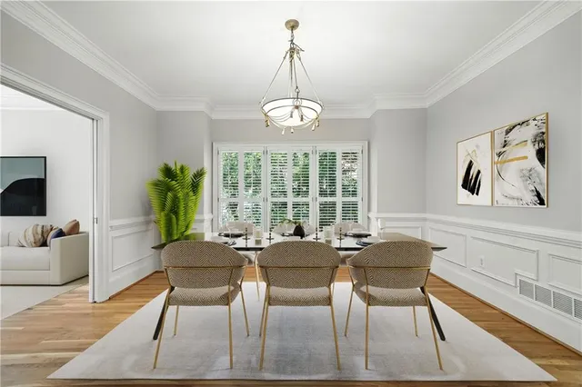 a dining room with furniture a chandelier and wooden floor
