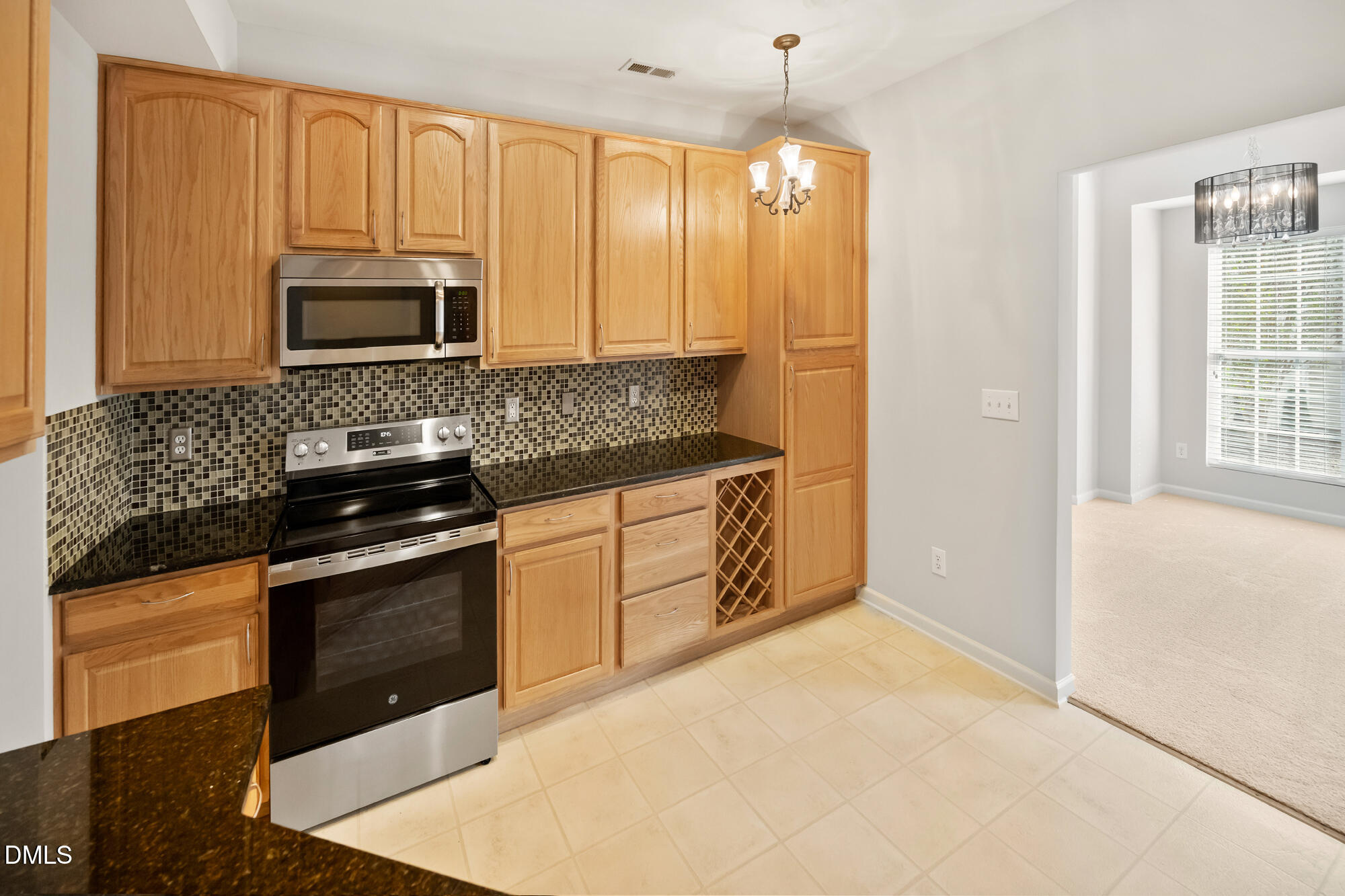3123 Winding Waters Way Raleigh, NC 27614 - Photo 24 of 57 a kitchen with stainless steel appliances granite countertop a stove a sink and a microwave