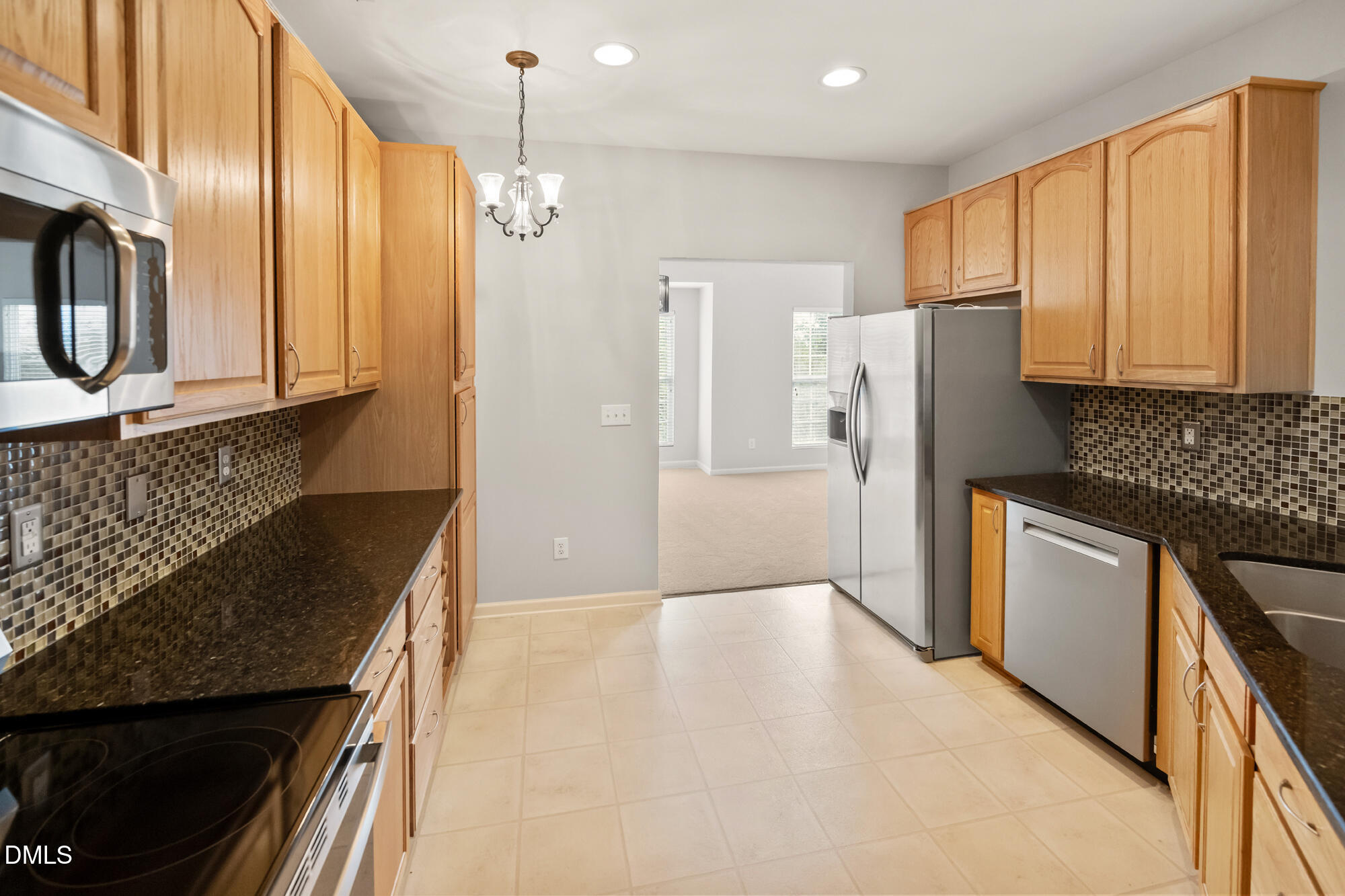 3123 Winding Waters Way Raleigh, NC 27614 - Photo 3 of 57 a kitchen with granite countertop a refrigerator stove and microwave