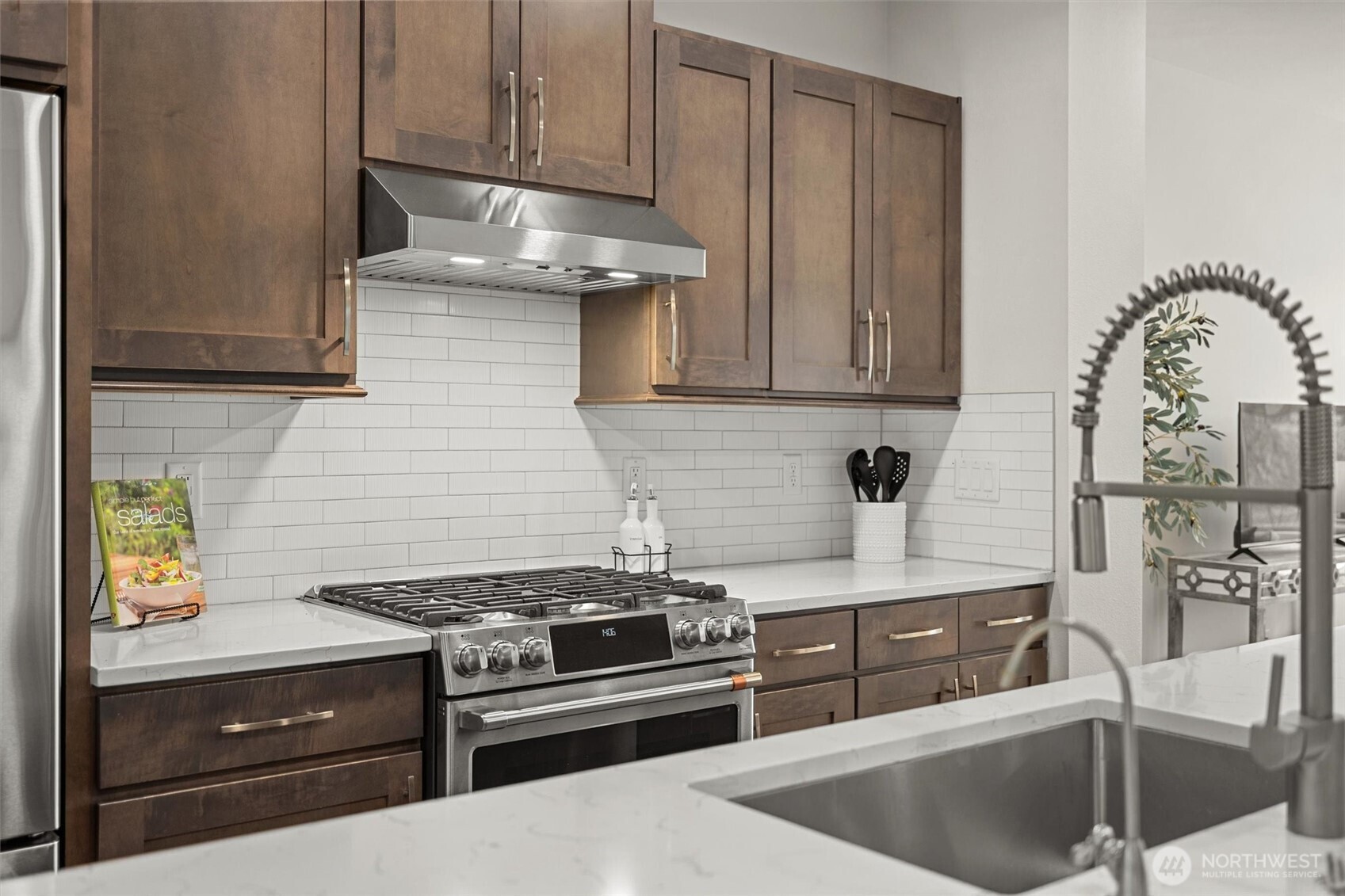 983 8th Avenue Northeast Issaquah, WA 98029 - Photo 8 of 40 a kitchen with stainless steel appliances granite countertop a sink stove and cabinets