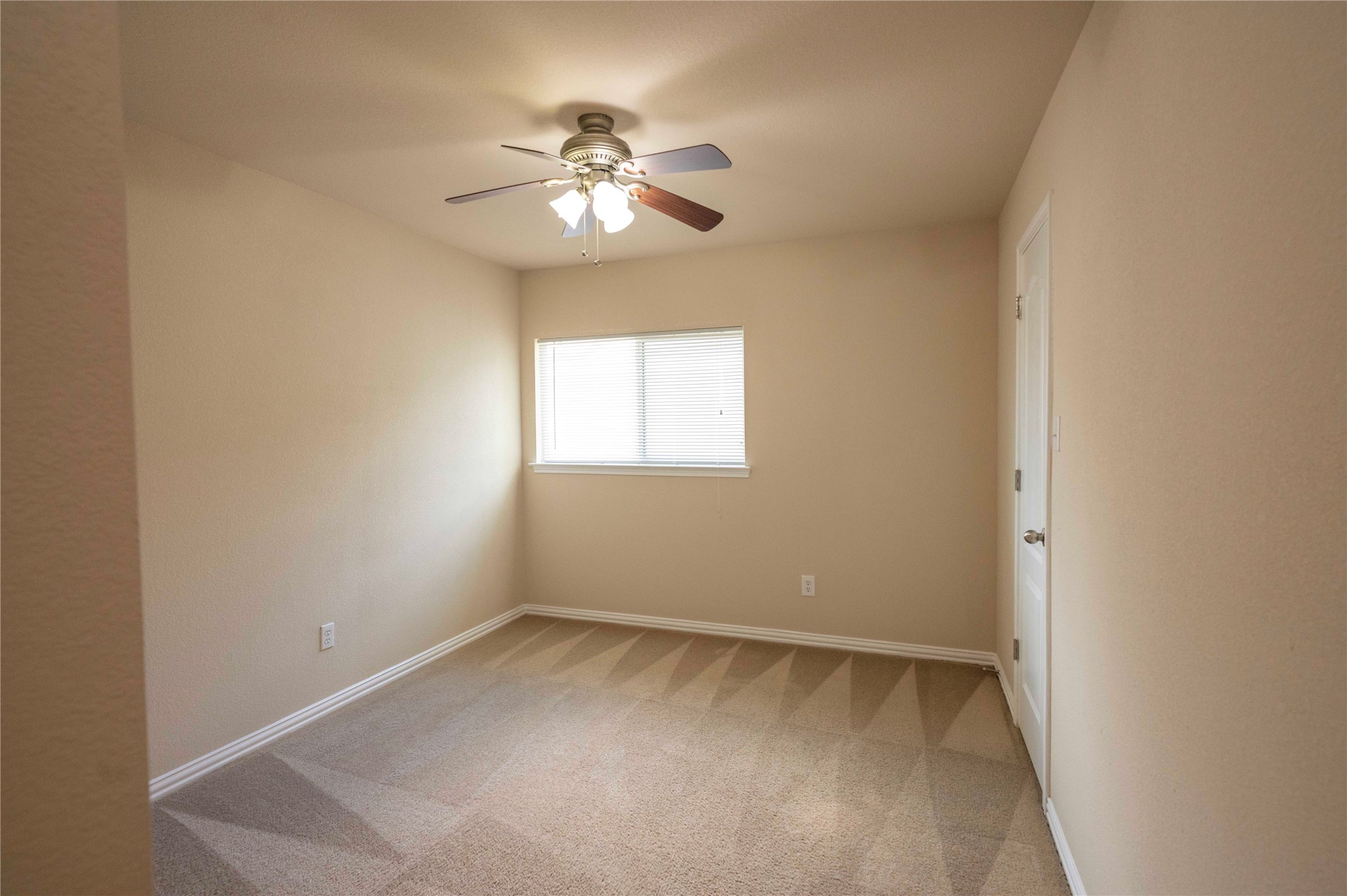 2070 Intrepid Drive Buda, TX 78610 - Photo 24 of 31 A well-lit bedroom features plush carpet and a convenient ceiling fan.