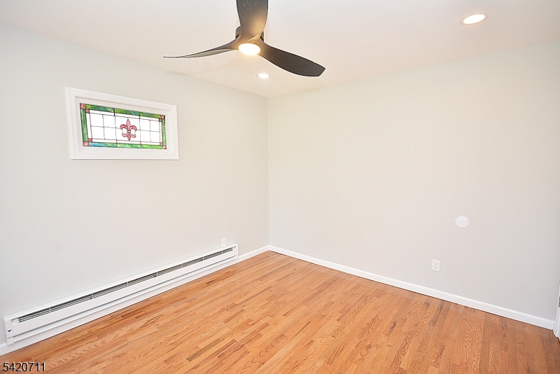 1324 George Street Plainfield, NJ 07062 - Photo 21 of 26 an empty room with wooden floor and windows