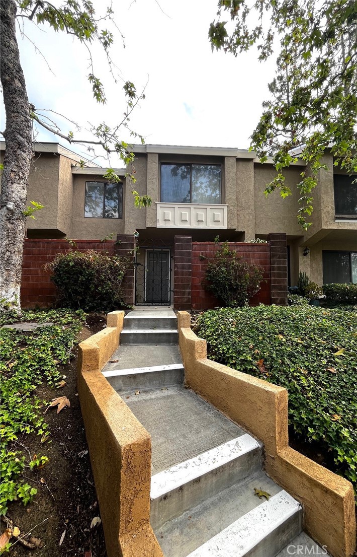1673 Sherwood Village Circle Placentia, CA 92870 - Photo 1 of 8 a view of a house with a yard plants and large tree