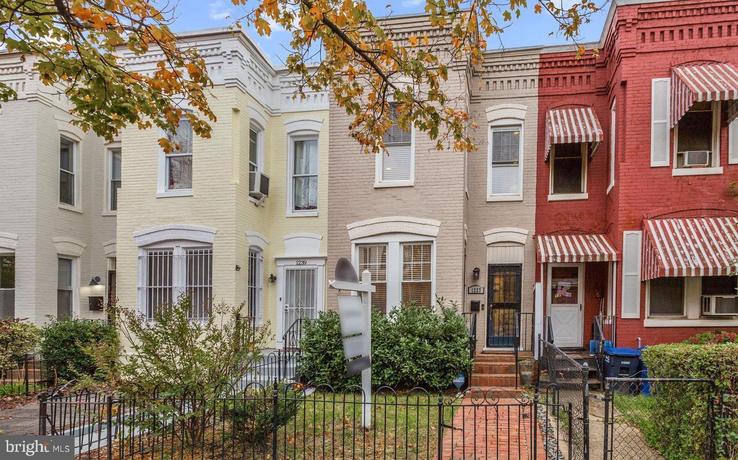 front view of a brick house with a small yard