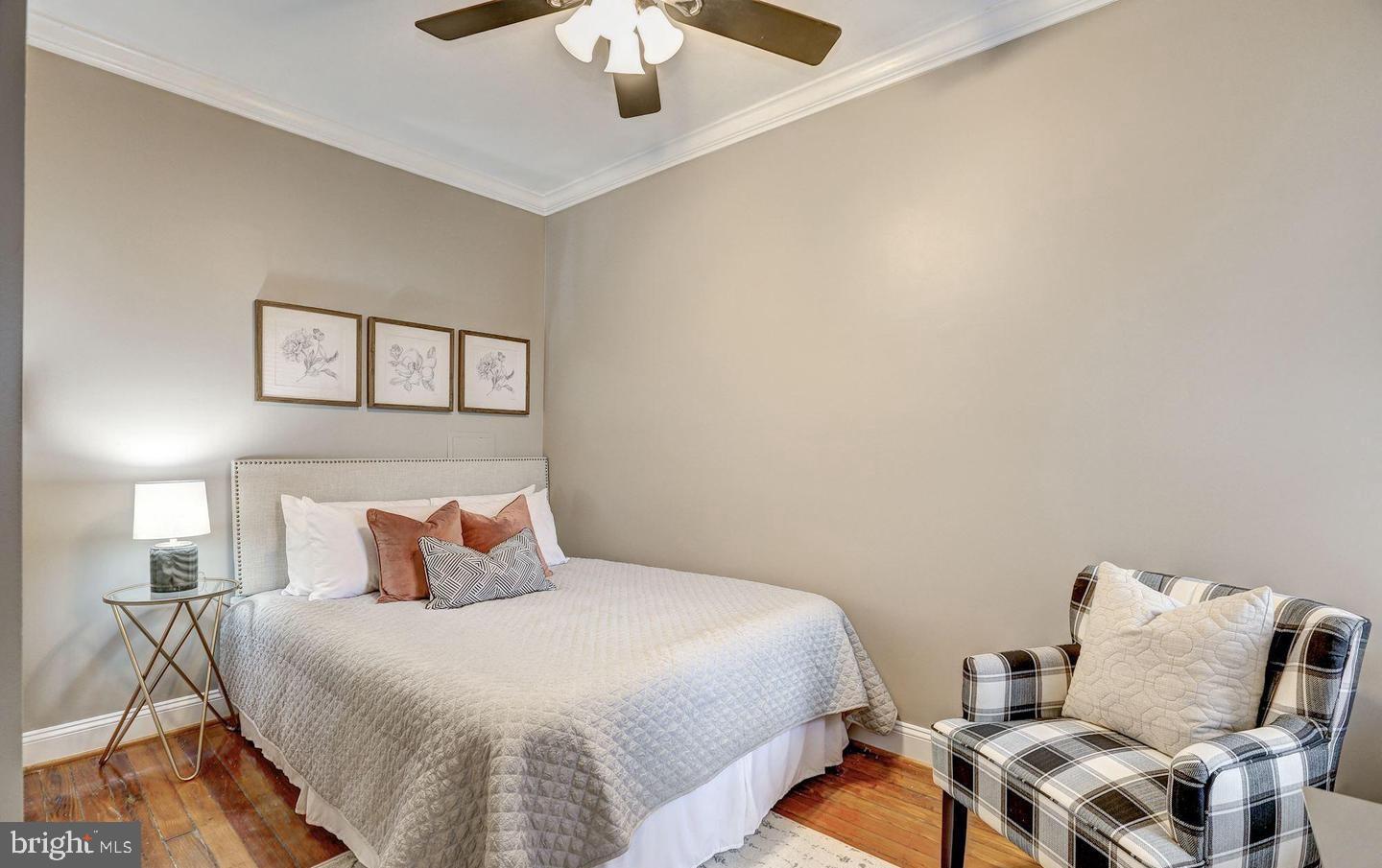 1237 I Street Northeast Washington, DC 20002 - Photo 23 of 27 a bedroom with a bed and a chandelier